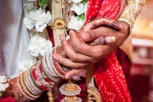 Sona and Amer holding hands by Resh Rall Wedding Photography, Leeds